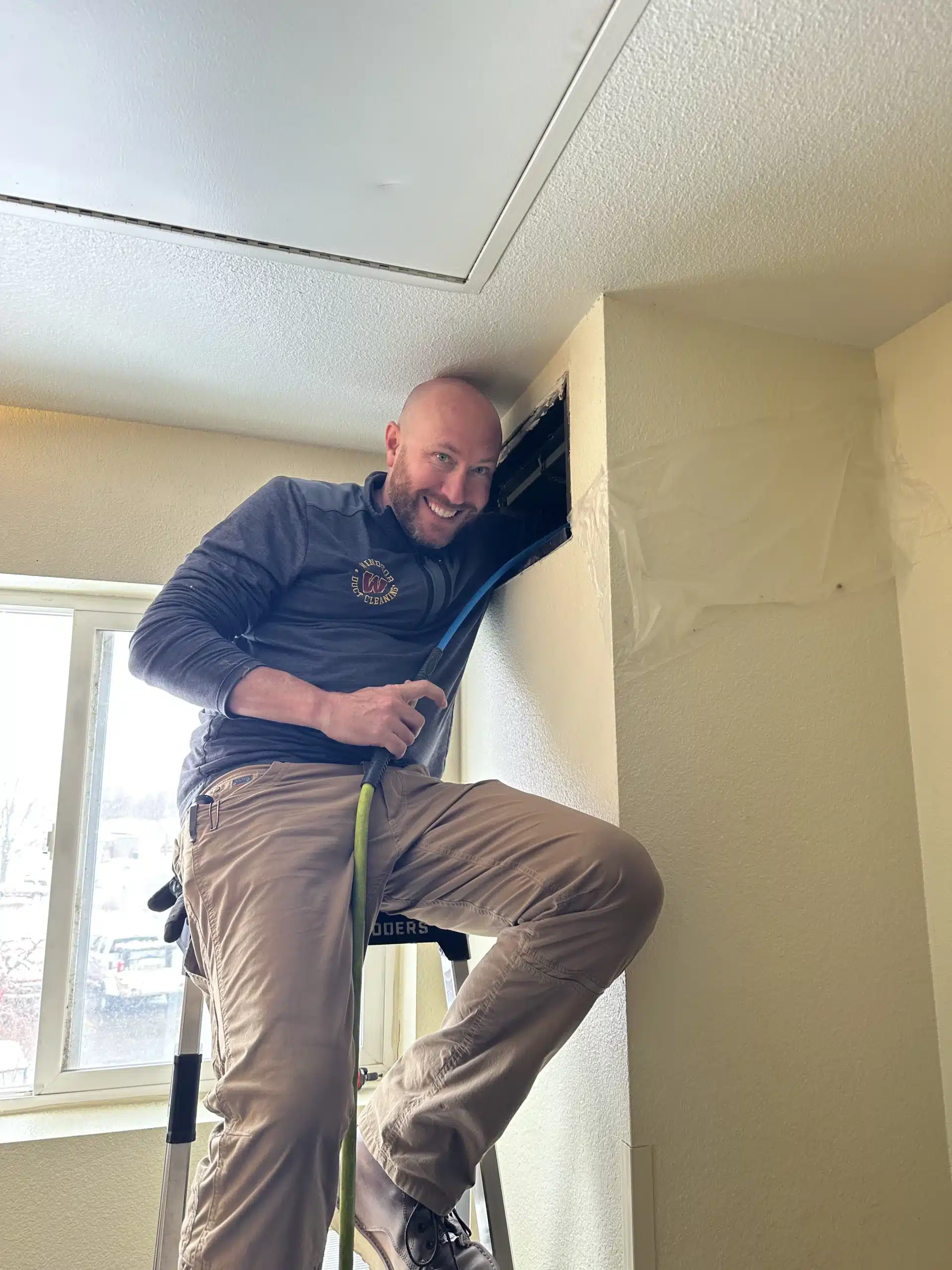 man cleaning air vent
